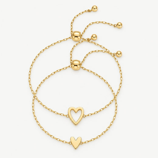 Matching heart bracelets in gold — open heart and full heart, worn together