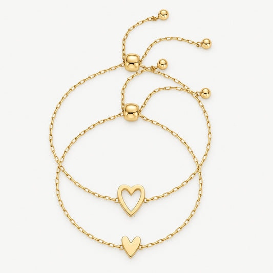 Matching heart bracelets in gold — open heart and full heart, worn together